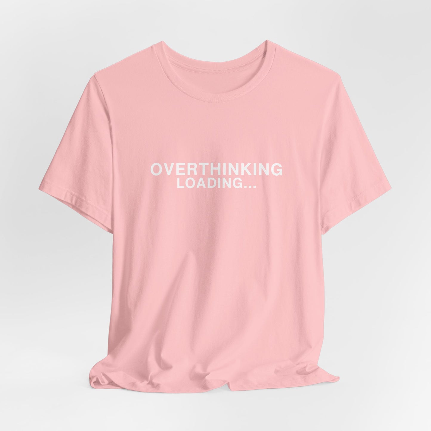 Mockup of a pink t-shirt featuring "OVERTHINKING LOADING..."