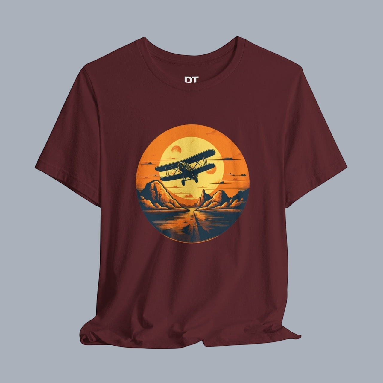 [Biplane graphic flying over mountains at sunset