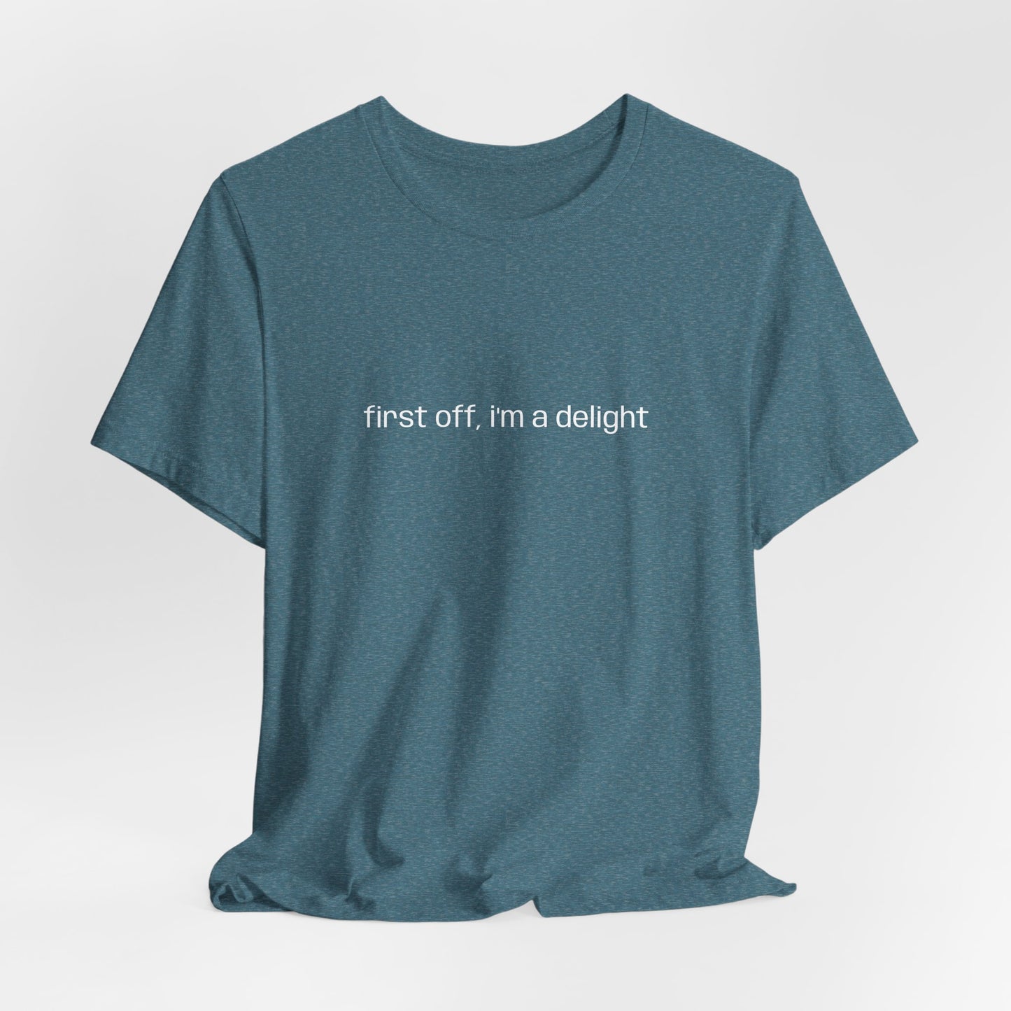 [Ensemble view of teal t-shirt with white text saying "first off, i'm a delight"
