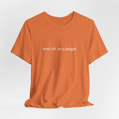 Bright orange t-shirt with statement "first off, i'm a delight" printed in white