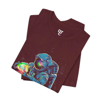 DailyThreadCo. maroon 100% cotton t-shirt with a graphic of an astronaut holding a rainbow nebula. Crew neck, short sleeves.