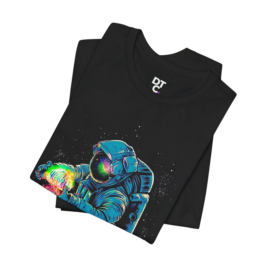 DailyThreadCo. black 100% cotton t-shirt with a neon astronaut graphic holding a rainbow nebula. Crew neck, short sleeves.