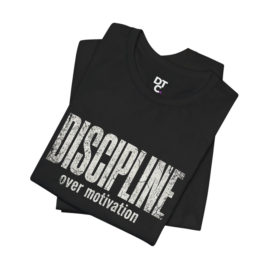 DailyThreadCo black 100% cotton t-shirt with distressed white text reading "DISCIPLINE over motivation" and a small DTC logo on the collar.