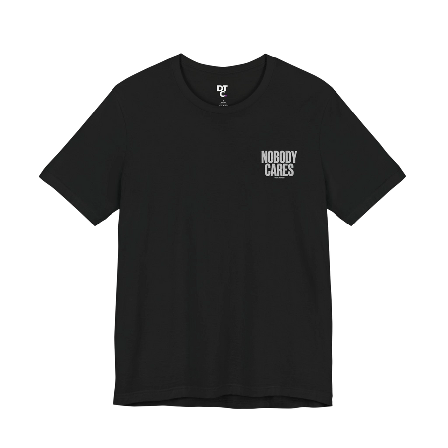 DailyThreadCo. black 100% cotton graphic tee with "Nobody Cares" text art on the chest. Crew neck, short sleeves.