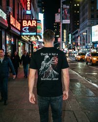 DailyThreadCo. black 100% cotton t-shirt with a graphic of a grim reaper holding a bloody anatomical heart and the text 