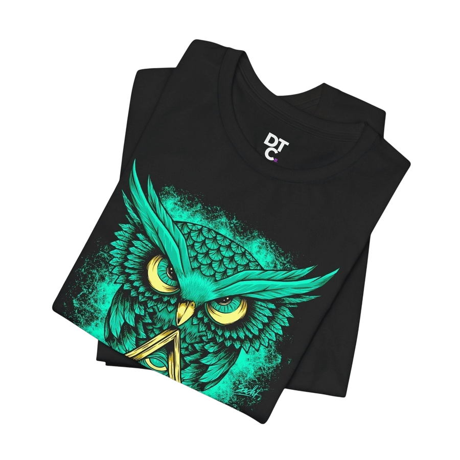 DailyThreadCo. black crew-neck t-shirt with a neon green owl graphic and yellow eyes, featuring a triangle symbol. 100% cotton.