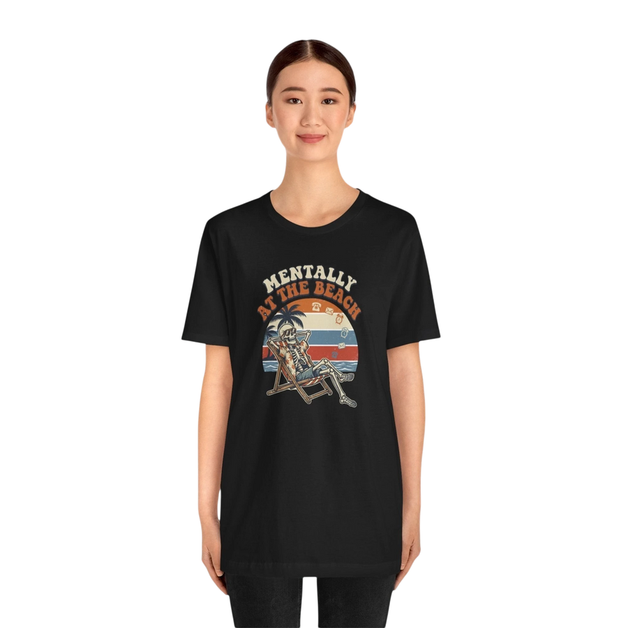 DailyThreadCo. black 100% cotton t-shirt with a retro graphic of a skeleton relaxing in a beach chair under palm trees with the text "Mentally at the Beach."
