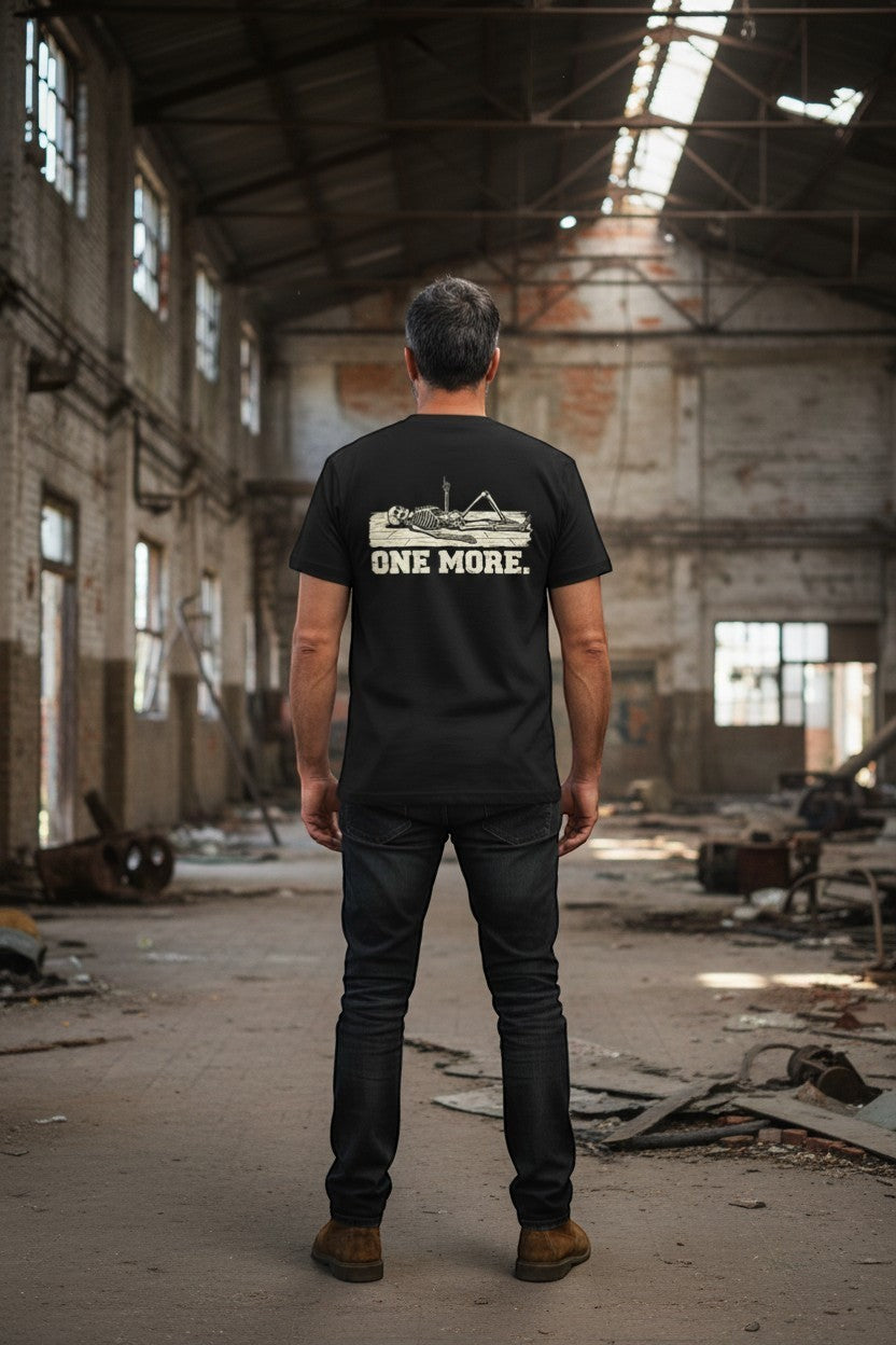 DailyThreadCo. black 100% Airlume cotton t-shirt with a skeleton graphic and "ONE MORE." text on the back.