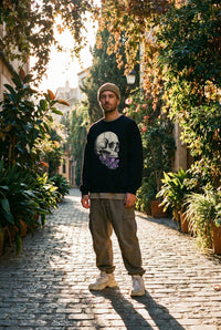 DailyThreadCo. black crewneck sweatshirt with a detailed skull graphic adorned with purple crystals on the chest.