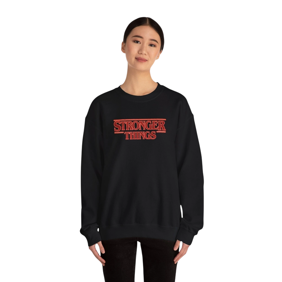 DailyThreadCo. black crewneck sweatshirt with "Stronger Things" retro red logo embroidery on chest. 50/50 cotton-polyester blend.