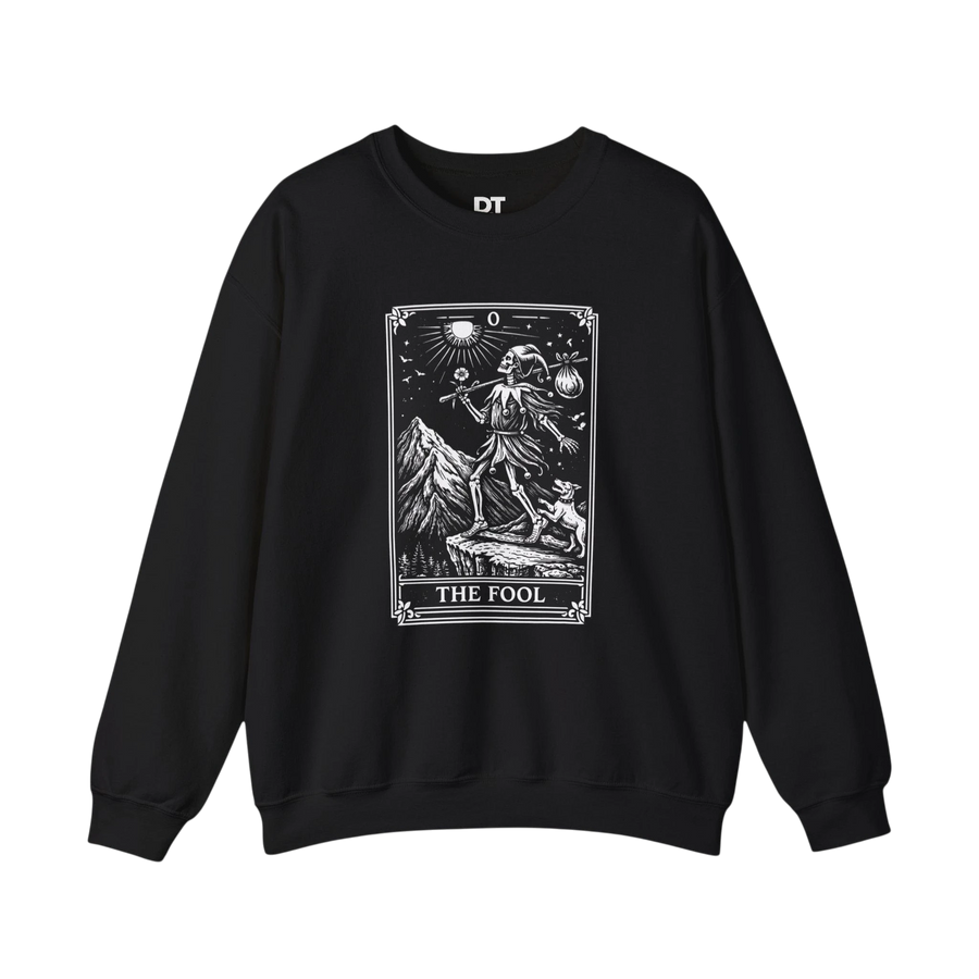 DailyThreadCo. black crewneck sweatshirt with a white graphic of The Fool tarot card, featuring a skeleton figure, a dog, mountains, and celestial symbols.