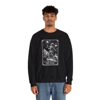 DailyThreadCo. black crewneck sweatshirt with a vintage tarot card graphic of The Fool, featuring a mountain landscape and celestial symbols.