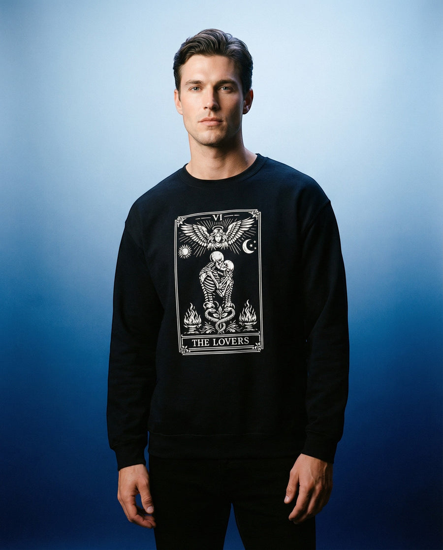 DailyThreadCo. black crewneck sweatshirt with a gothic tarot card graphic of 'The Lovers' featuring skeletons, angelic wings, and celestial motifs.