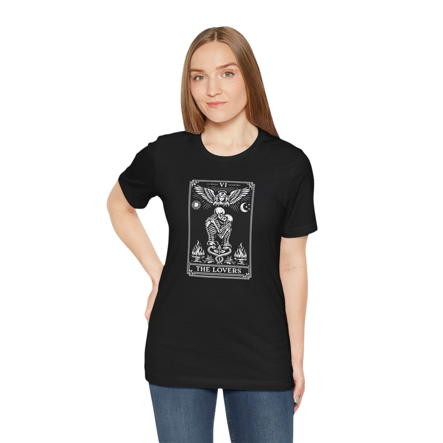 DailyThreadCo. black 100% cotton t-shirt with a monochrome 'The Lovers' tarot card graphic. Features skeleton figures, angelic wings, sun, moon, and flames.