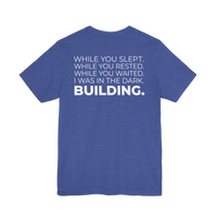 DailyThreadCo. blue cotton t-shirt with white text on back: 'While You Slept. While You Rested. While You Waited. I Was In The Dark. BUILDING.'