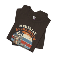 DailyThreadCo. brown 100% cotton t-shirt with a retro graphic of a skeleton relaxing on a beach chair under palm trees, text reads 