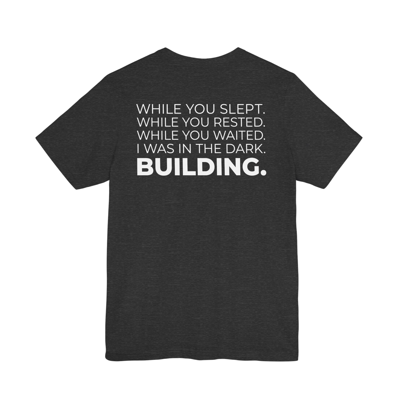 DailyThreadCo. dark grey cotton t-shirt with white text on back: 'While You Slept. While You Rested. While You Waited. I Was In The Dark. BUILDING.'