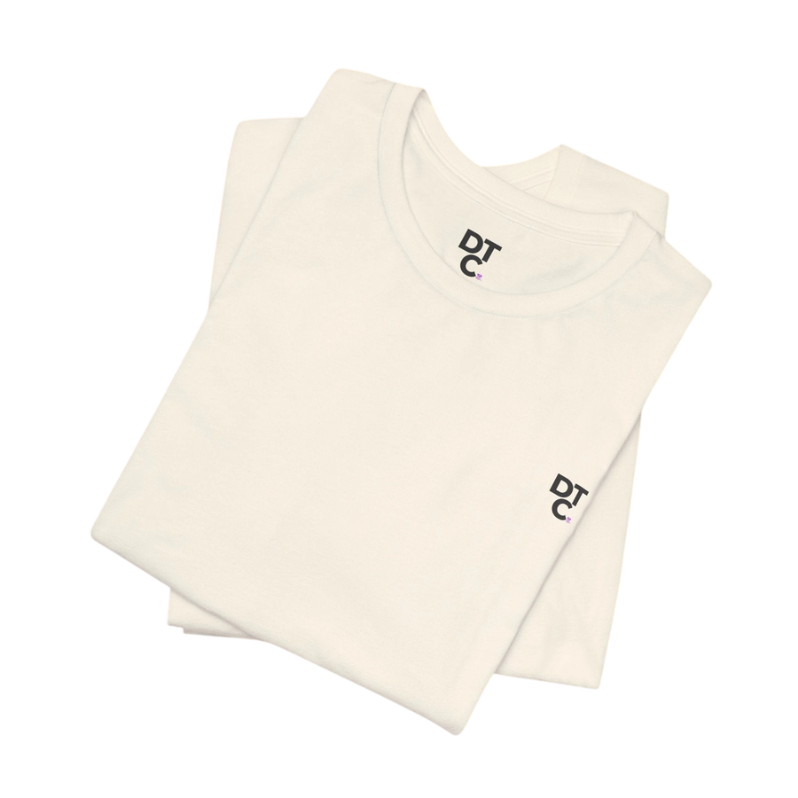 DailyThreadCo. cream 100% cotton crew neck t-shirt with small embroidered logo on chest and sleeve.