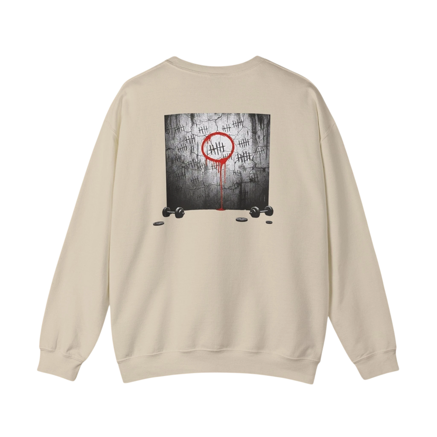 DailyThreadCo. cream crewneck sweatshirt with a graphic of tally marks on a cracked wall, a red circle, and dripping red paint. Two dumbbells and weights are at the bottom.