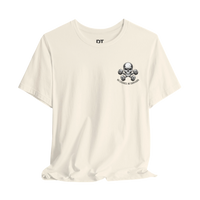DailyThreadCo. cream 100% Airlume cotton t-shirt with a small skull and dumbbells graphic on the left chest.
