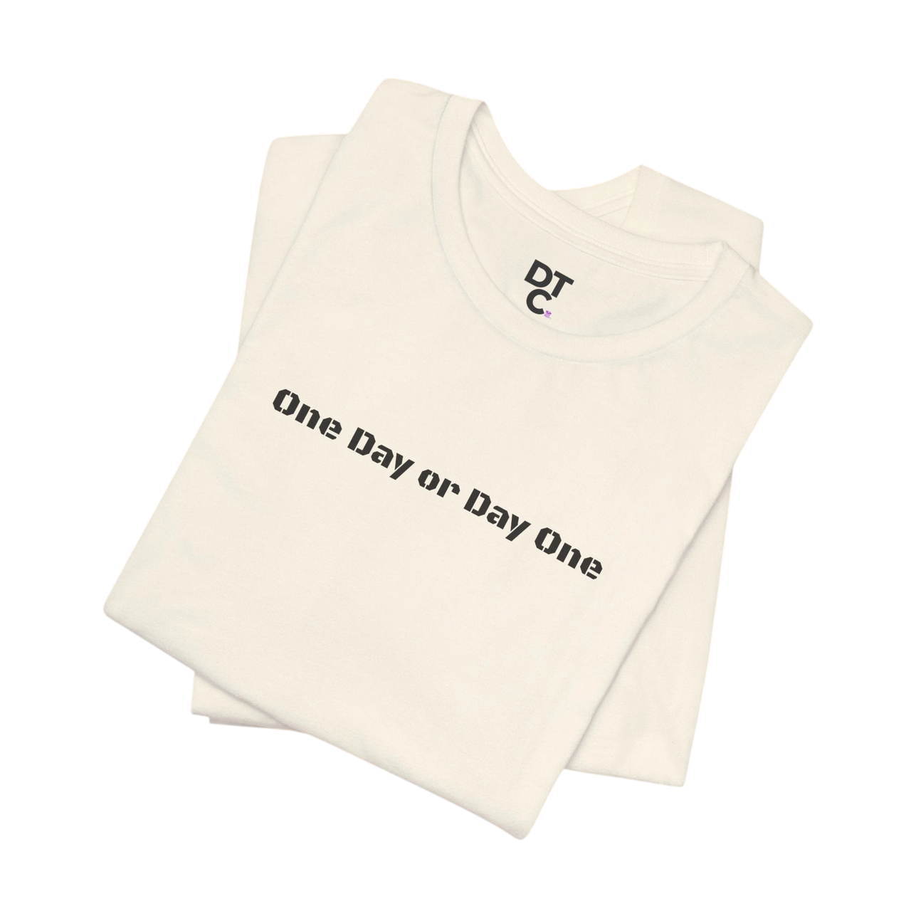 DailyThreadCo. cream cotton t-shirt with black "One Day or Day One" graphic print and DTC logo.