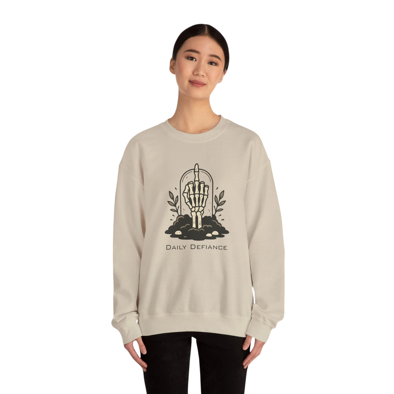 DailyThreadCo. cream crewneck sweatshirt with a skeleton hand graphic giving the middle finger, surrounded by foliage and text Daily Defiance.