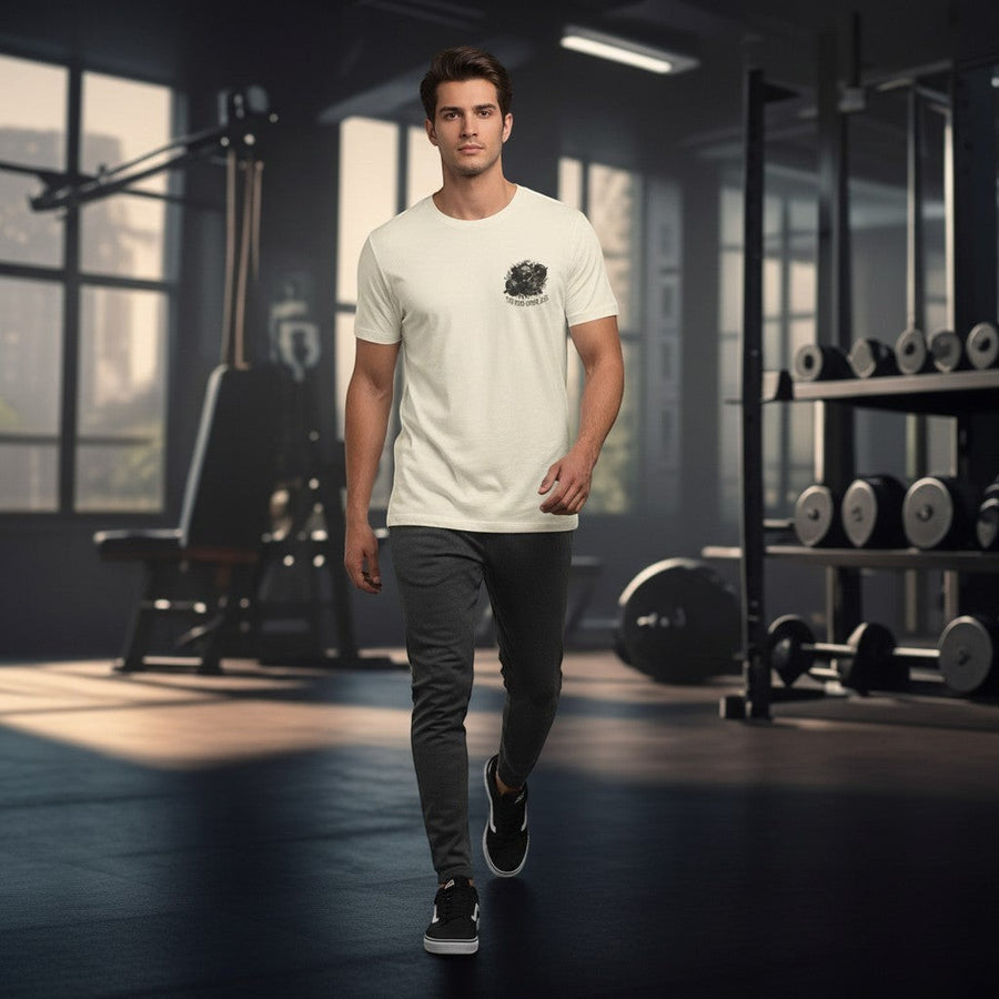 DailyThreadCo. cream cotton t-shirt with a skull and barbell graphic and "The Iron Never Lies" text on the chest.