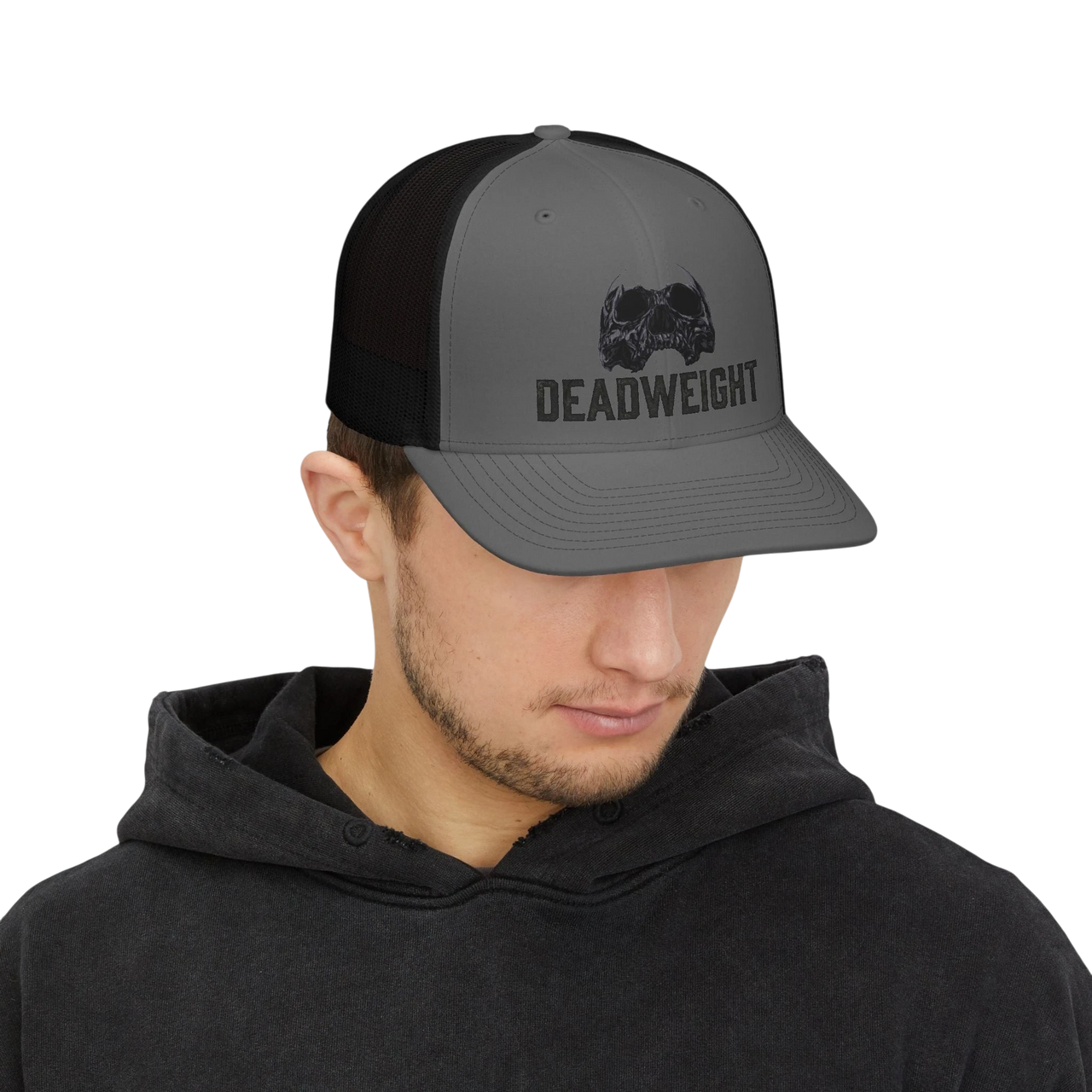 DailyThreadCo. grey trucker cap with black mesh back, featuring a distressed skull emblem and "DEADWEIGHT" logo on the front panel.