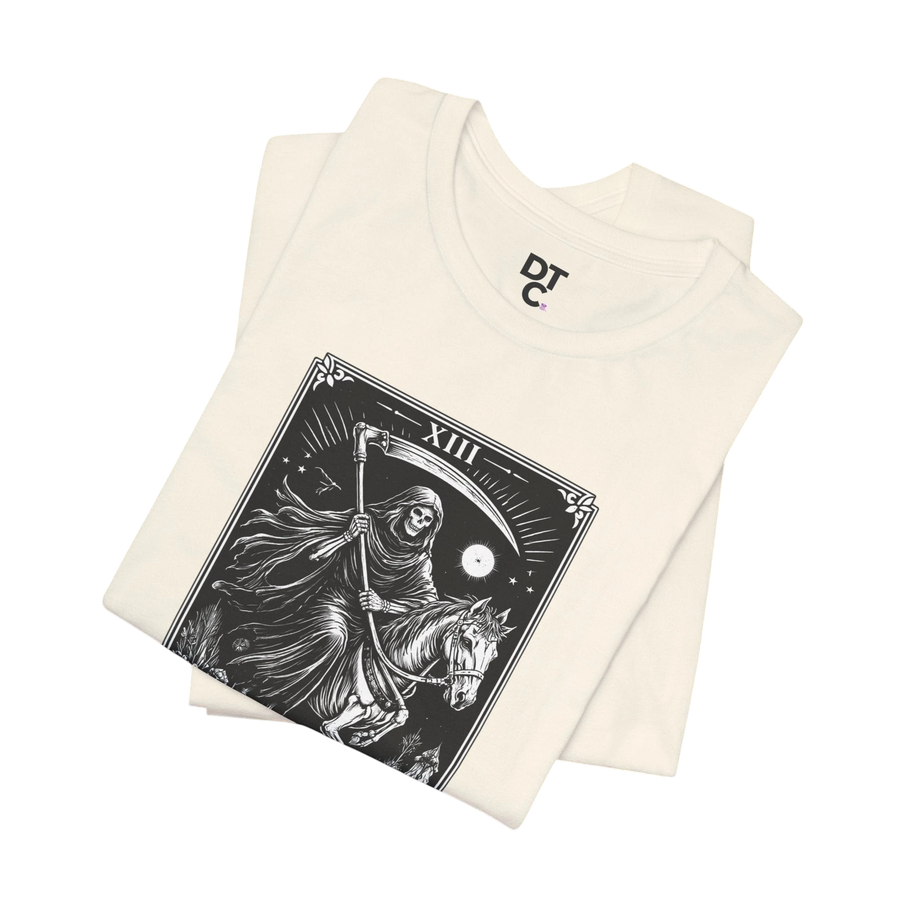 DailyThreadCo. cream 100% cotton t-shirt with a black Death Tarot card graphic featuring a skeleton on a horse and a scythe.