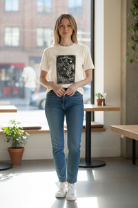 DailyThreadCo. cream cotton t-shirt with a black graphic print of the Death Tarot card, featuring a skeleton on a horse.