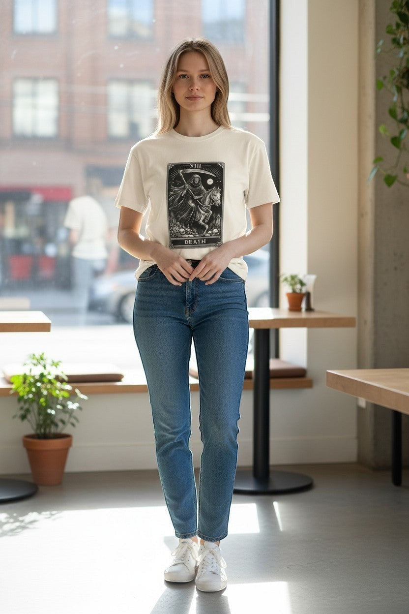 DailyThreadCo. cream cotton t-shirt with a black graphic print of the Death Tarot card, featuring a skeleton on a horse.