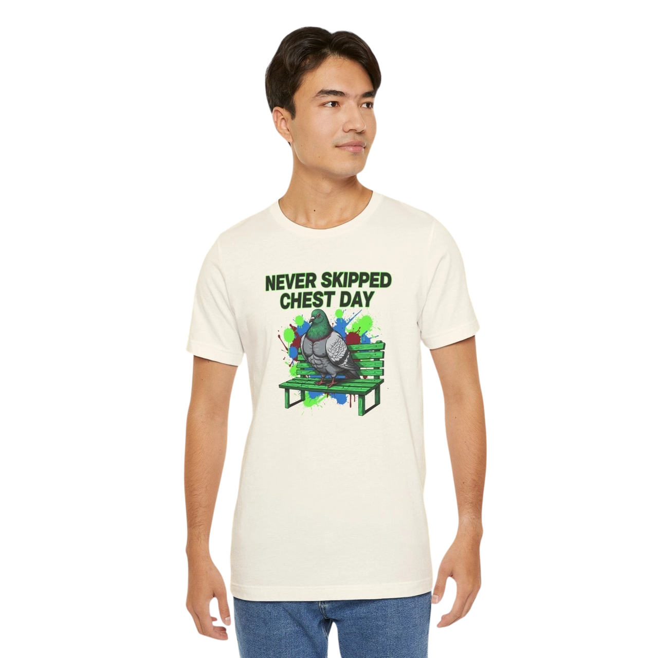 DailyThreadCo. cream cotton t-shirt with a graphic print of a muscular pigeon sitting on a green park bench. Text reads "NEVER SKIPPED CHEST DAY".