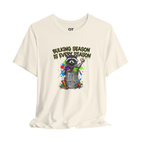 DailyThreadCo. cream 100% cotton t-shirt with a funny graphic of a raccoon in a trash can with the text 