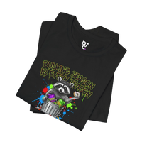 DailyThreadCo. black 100% cotton t-shirt with a funny graphic of a raccoon in a trash can holding a donut, text reads 