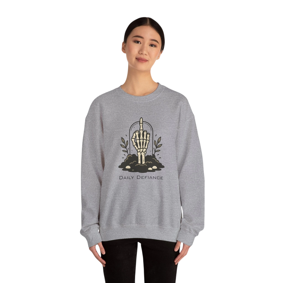 DailyThreadCo. grey crewneck sweatshirt with a skeleton hand graphic giving the middle finger, surrounded by foliage and the words "Daily Defiance".