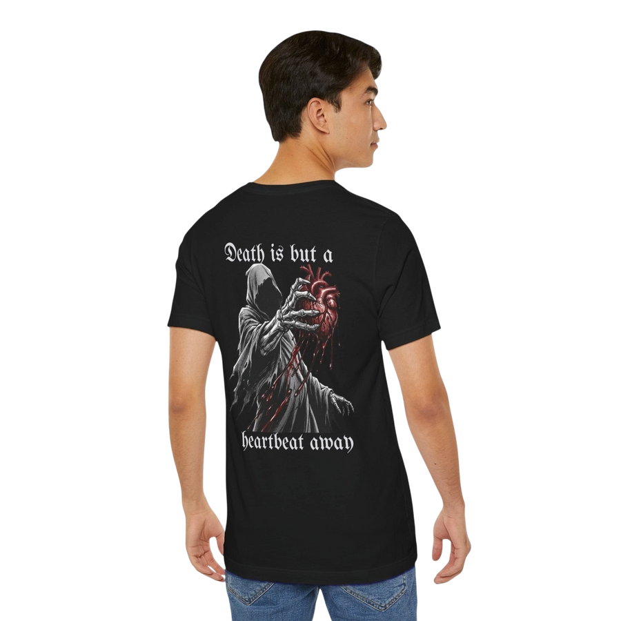DailyThreadCo. black 100% cotton t-shirt with a graphic of the Grim Reaper holding a bloody anatomical heart and the text "Death is but a heartbeat away".