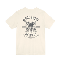 DailyThreadCo. cream cotton t-shirt with a graphic print of a skull between crossed barbells, reading 