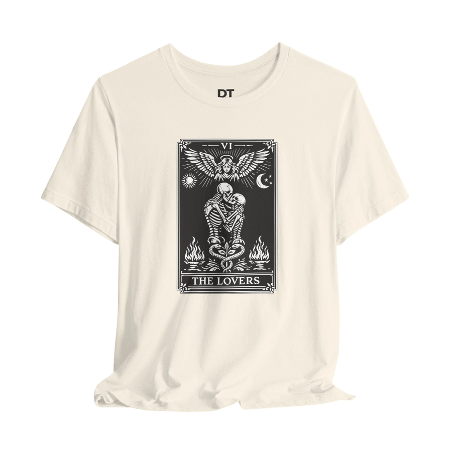 DailyThreadCo. cream cotton t-shirt with black 'The Lovers' tarot card graphic. Features skeleton couple, angel, sun, moon, and flames.