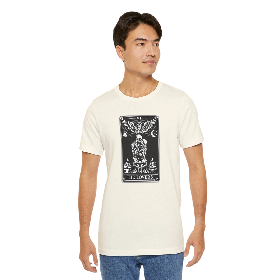 DailyThreadCo. cream cotton t-shirt with black and white 'The Lovers' tarot card graphic. Features skeleton couple, angel, sun, moon, and flames.