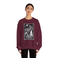 DailyThreadCo. maroon crewneck sweatshirt with a black and white tarot strength card graphic featuring a woman and a lion.