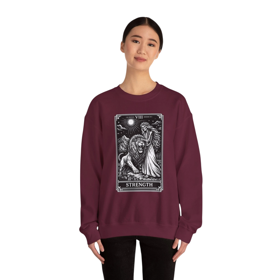 DailyThreadCo. maroon crewneck sweatshirt with a black and white tarot strength card graphic featuring a woman and a lion.