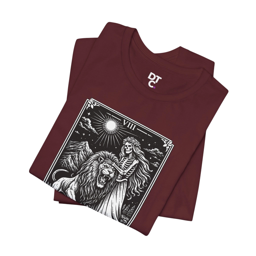 DailyThreadCo. maroon 100% cotton t-shirt with vintage Strength tarot card illustration of a skeleton woman and a lion.