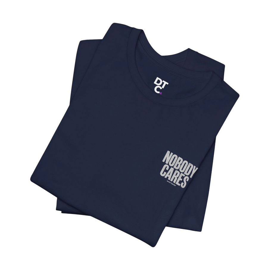 DailyThreadCo. navy blue 100% cotton graphic tee with "Nobody Cares" text and DTC logo.