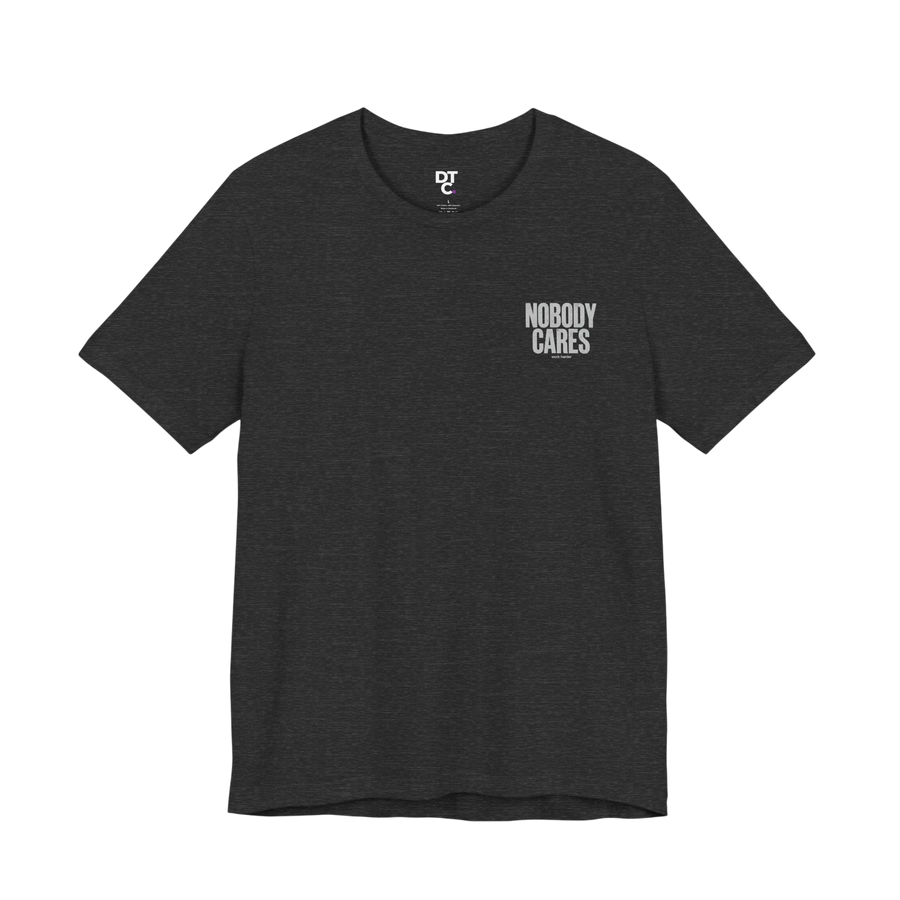 DailyThreadCo. dark grey cotton graphic tee with "Nobody Cares" text on the chest and a small logo on the collar.