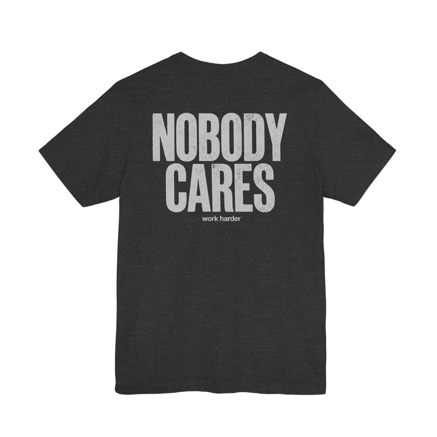 DailyThreadCo. dark grey cotton t-shirt with white distressed text graphic reading "NOBODY CARES" and "work harder" below.