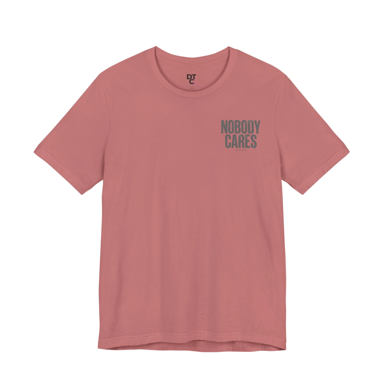 DailyThreadCo. dusty rose 100% cotton graphic tee with "Nobody Cares" text on the chest.