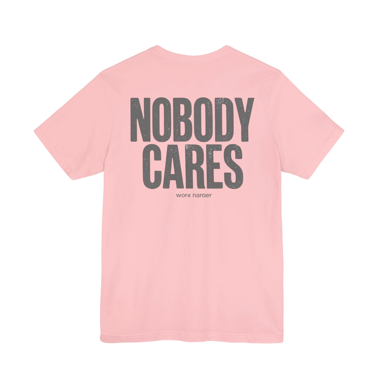 DailyThreadCo. pink 100% cotton graphic tee with "NOBODY CARES" and "work harder" text art in grey.