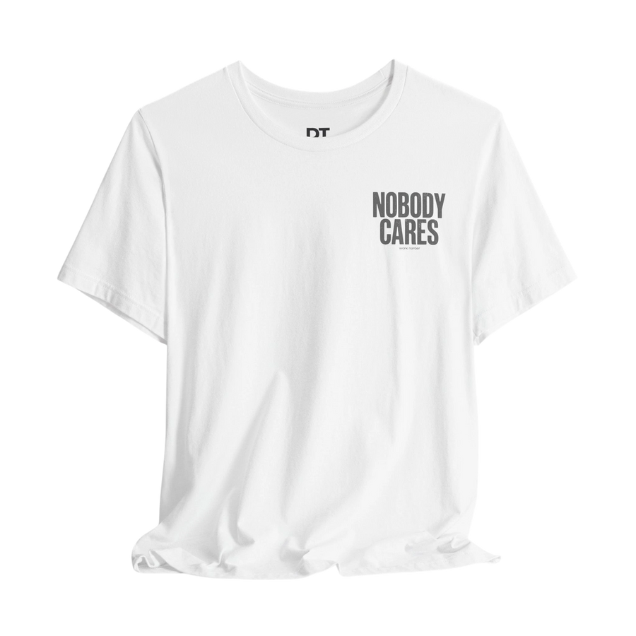DailyThreadCo. white 100% cotton graphic tee with "NOBODY CARES" text art on the chest.