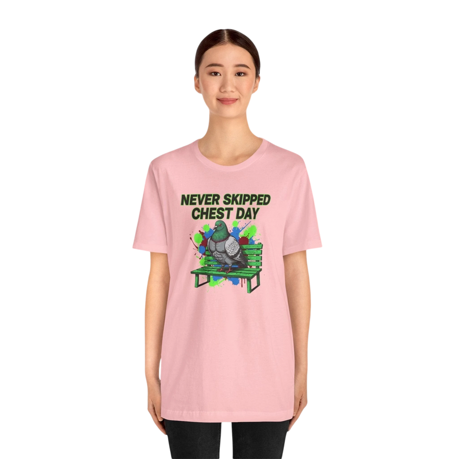 DailyThreadCo. pink cotton t-shirt with a graphic of a pigeon on a bench and the text "NEVER SKIPPED CHEST DAY".