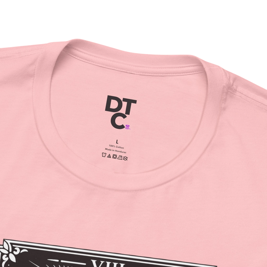 DailyThreadCo. pink 100% cotton crew neck t-shirt with vintage Strength tarot card illustration of woman and lion.